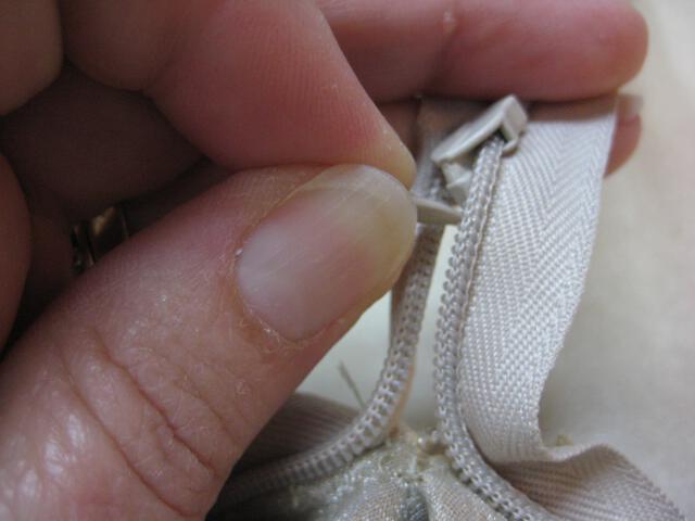 begin pulling zipper tab